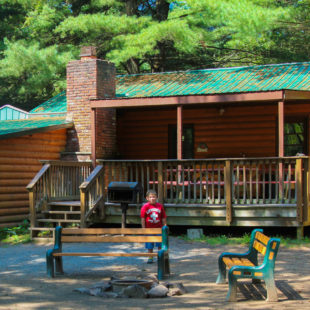 young boy standing outside cabin area Indian Head Canoeing Rafting Kayaking Tubing Delaware River