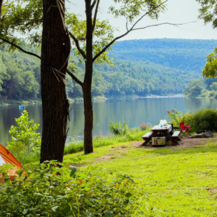 sun reflecting on river surrounded by trees near picnic area Indian Head Canoeing Rafting Kayaking Tubing Delaware River