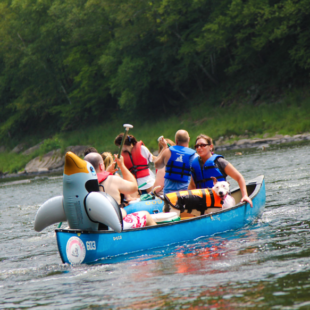 two groups and a dog with life jacket in canoeIndian Head Canoeing Rafting Kayaking Tubing Delaware River