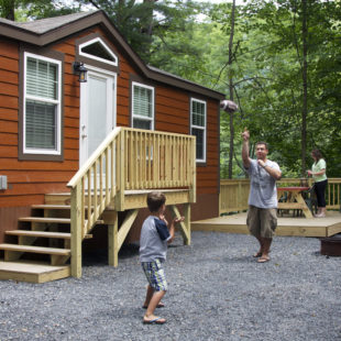 dad and son playing catch outside cabin Indian Head Canoeing Rafting Kayaking Tubing Delaware River
