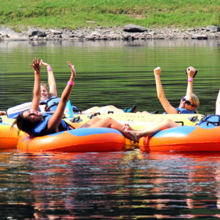 group of 7 enjoying calm waters and scenic views on river Indian Head Canoeing Rafting Kayaking Tubing Delaware River