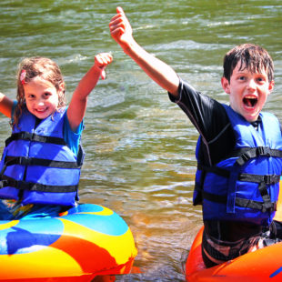 two excited kids in their tubes on the river Indian Head Canoeing Rafting Kayaking Tubing Delaware River