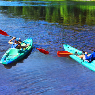 two young men in their own kayaks in Dingmans Ferry Indian Head Canoeing Rafting Kayaking Tubing Delaware River